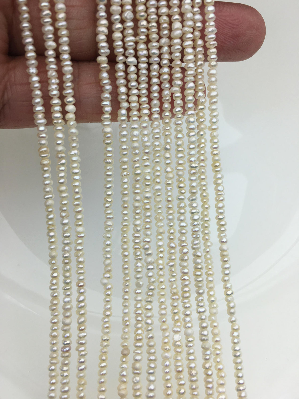 White Button Freshwater Pearl Strand — 2.5–3 mm