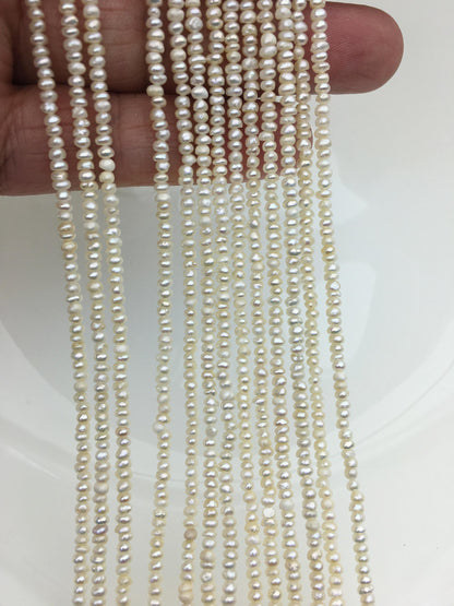 White Button Freshwater Pearl Strand — 2.5–3 mm