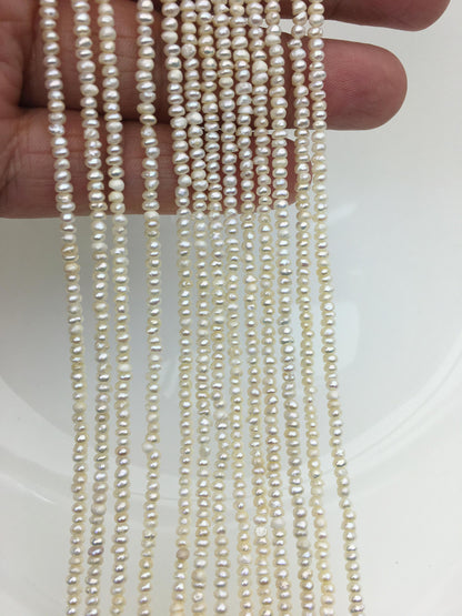 White Button Freshwater Pearl Strand — 2.5–3 mm